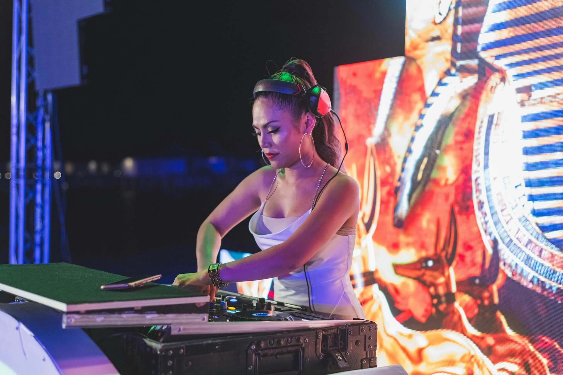 female dj playing music with a mixer