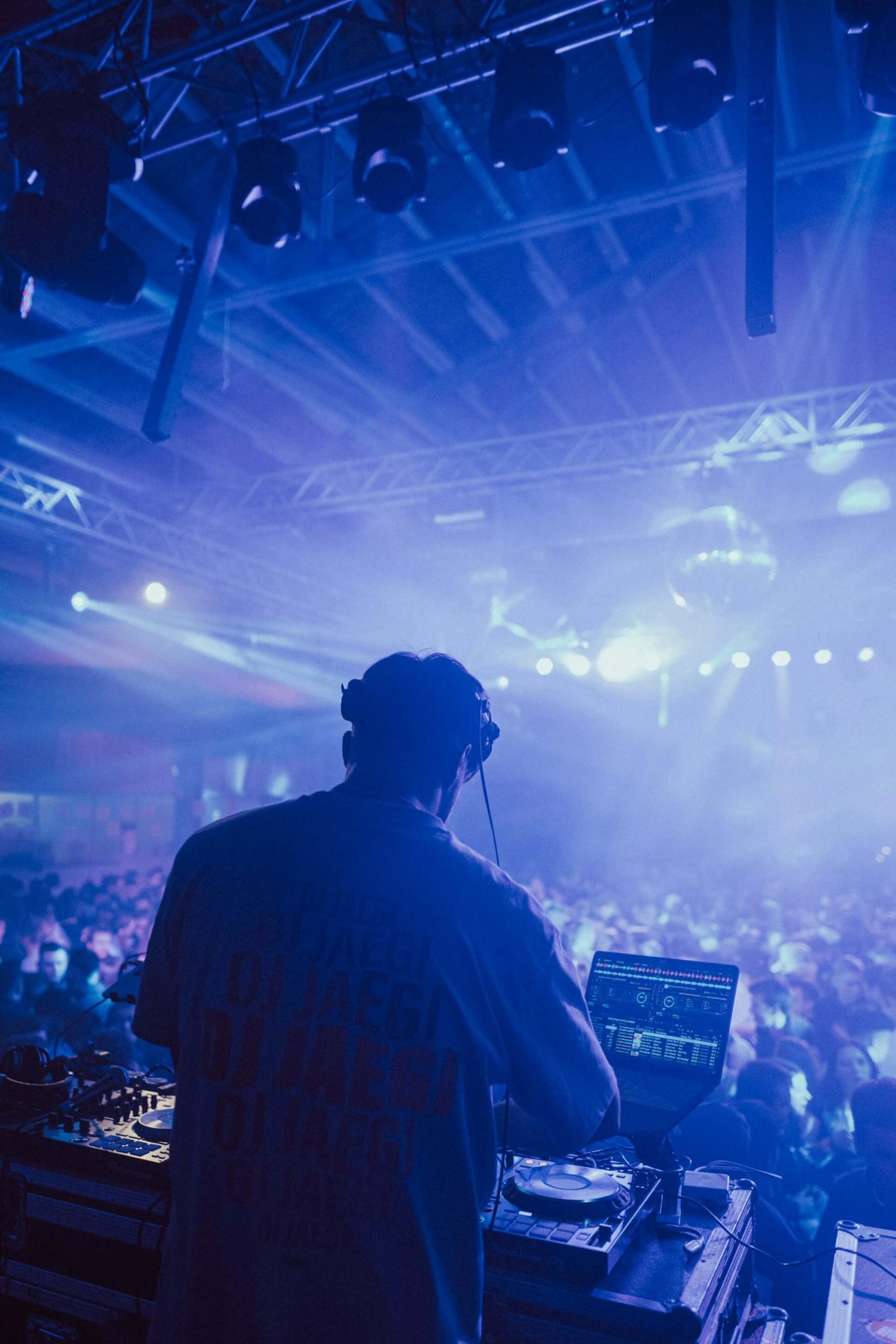 dj playing music on an event in dark atmosphere